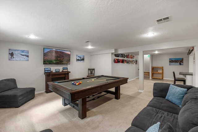 rec room with visible vents, a textured ceiling, and light colored carpet
