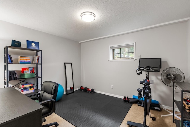 unfurnished office featuring baseboards and a textured ceiling