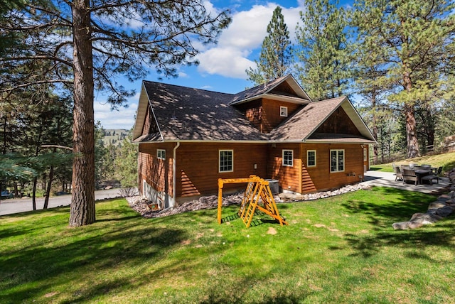 rear view of property featuring a yard, central air condition unit, and a patio