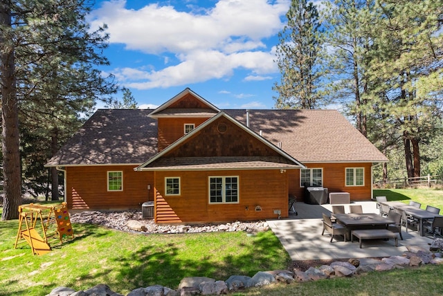 back of property featuring fence, a patio area, a lawn, and central AC unit