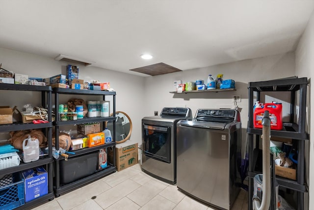 clothes washing area with recessed lighting, independent washer and dryer, light tile patterned floors, and laundry area