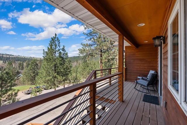 balcony featuring a view of trees