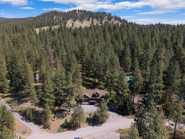 birds eye view of property with a view of trees