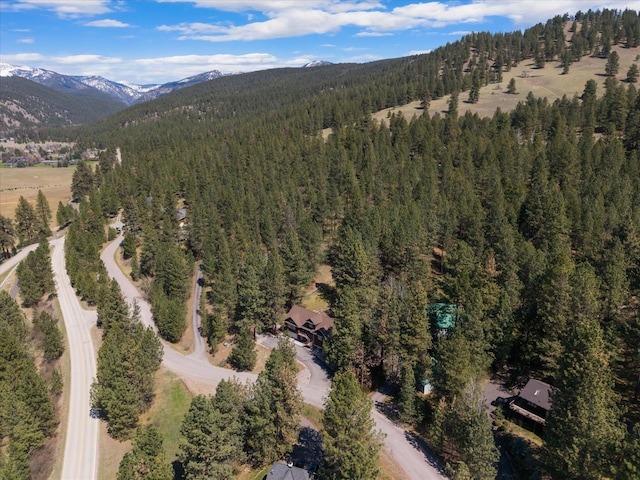 birds eye view of property featuring a view of trees and a mountain view