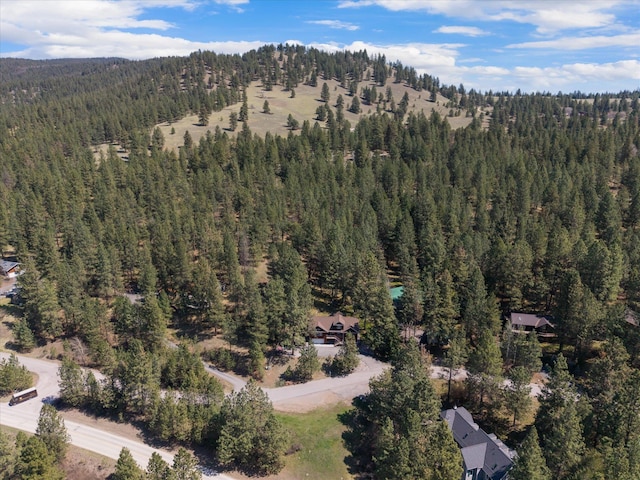 birds eye view of property featuring a wooded view