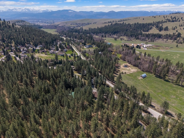 bird's eye view featuring a forest view and a mountain view