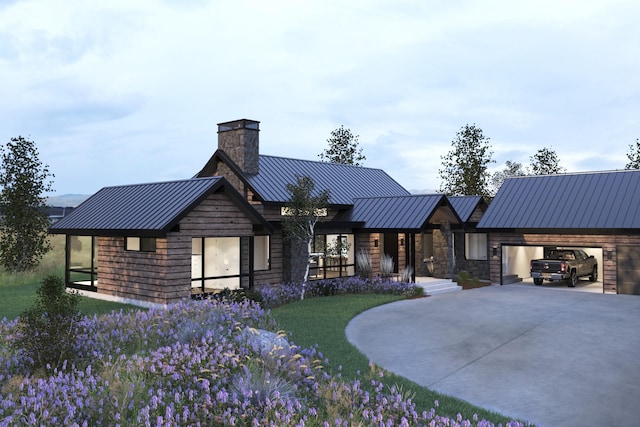 view of front of home featuring a front lawn, a standing seam roof, stone siding, concrete driveway, and metal roof
