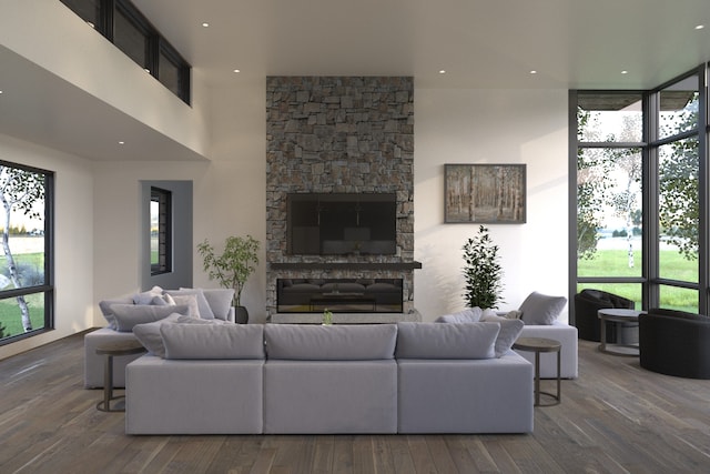 living room with hardwood / wood-style floors and a stone fireplace