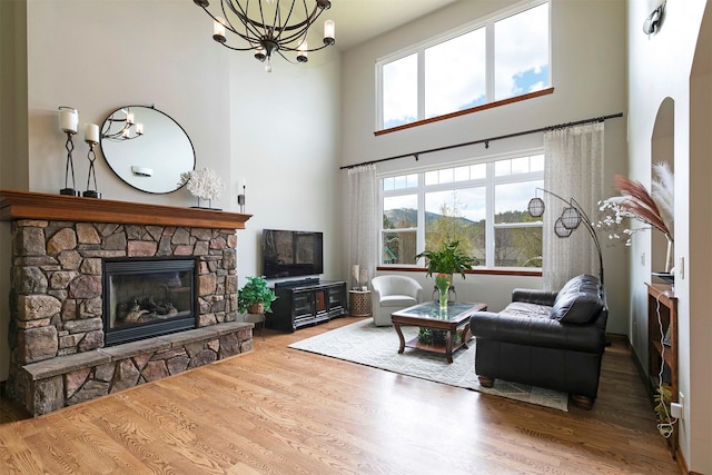 2200 Rafferty Ln, Missoula, MT 59804 - living area with wood finished floors, a fireplace, a towering ceiling, and a chandelier