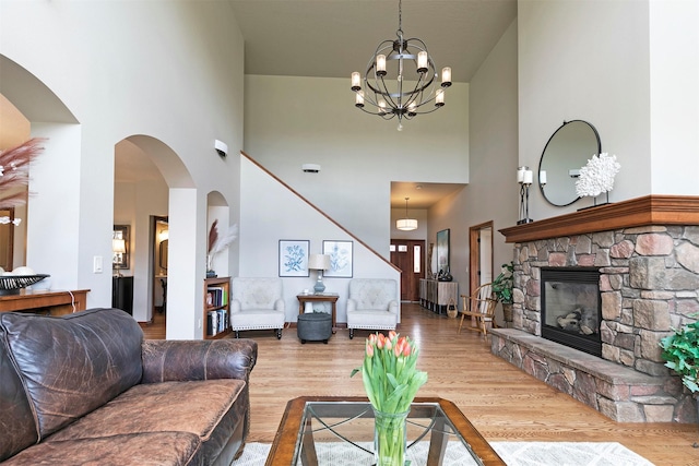 2200 Rafferty Ln, Missoula, MT 59804 - living room with a high ceiling, a chandelier, wood finished floors, a fireplace, and arched walkways