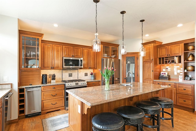 2200 Rafferty Ln, Missoula, MT 59804 - kitchen with appliances with stainless steel finishes, brown cabinetry, backsplash, light wood-type flooring, and recessed lighting