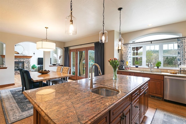 2200 Rafferty Ln, Missoula, MT 59804 - kitchen featuring stainless steel dishwasher, light wood-style floors, a center island with sink, hanging light fixtures, and recessed lighting