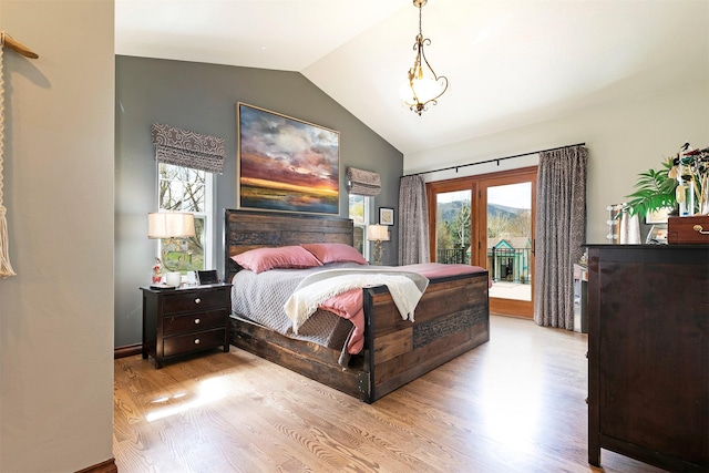 2200 Rafferty Ln, Missoula, MT 59804 - bedroom with access to outside, vaulted ceiling, and wood finished floors