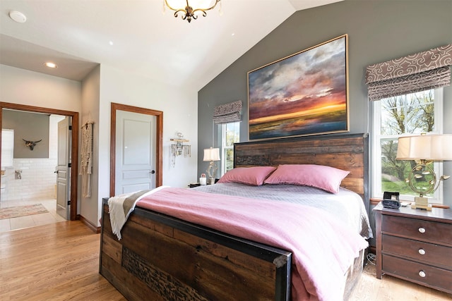 2200 Rafferty Ln, Missoula, MT 59804 - bedroom with vaulted ceiling, light wood-style flooring, and ensuite bath