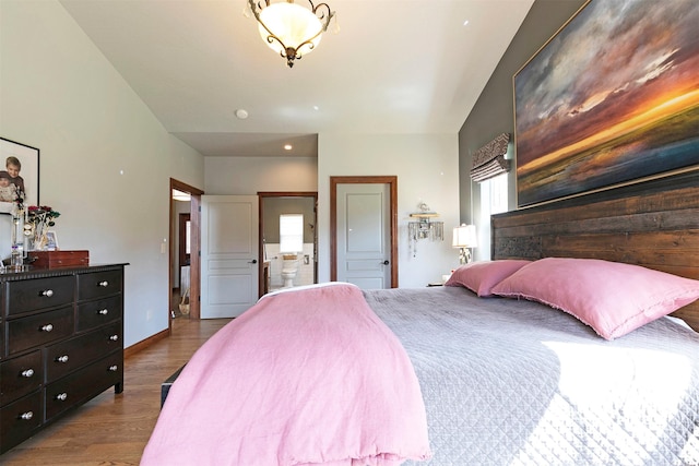 2200 Rafferty Ln, Missoula, MT 59804 - bedroom featuring wood finished floors, ensuite bath, and multiple windows