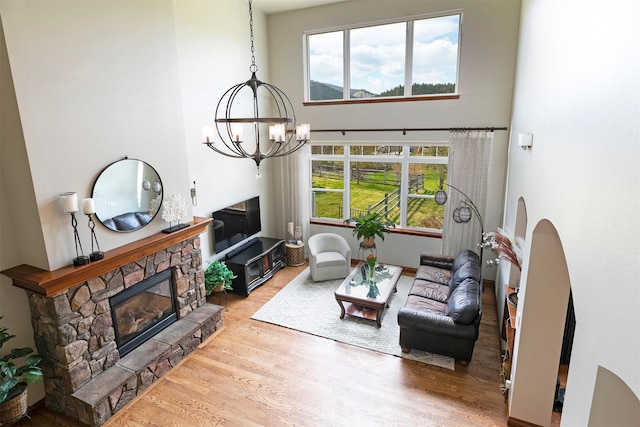2200 Rafferty Ln, Missoula, MT 59804 - living area with wood finished floors, a chandelier, a fireplace, and a high ceiling