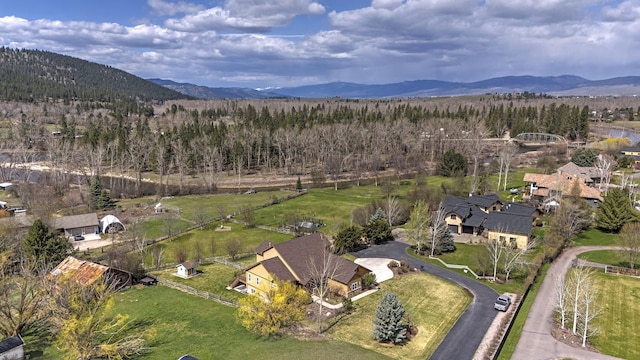 2200 Rafferty Ln, Missoula, MT 59804 - aerial overview of property's location with a mountain backdrop and a heavily wooded area