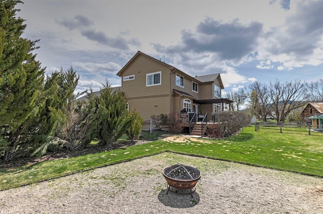 2200 Rafferty Ln, Missoula, MT 59804 - rear view of house featuring an outdoor fire pit, a fenced backyard, and a wooden deck