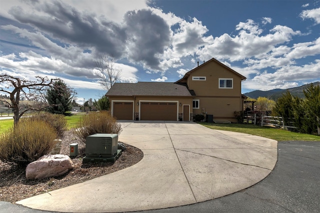 2200 Rafferty Ln, Missoula, MT 59804 - view of home's exterior featuring driveway, an attached garage, a yard, and a mountain view