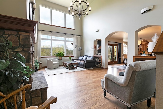 2200 Rafferty Ln, Missoula, MT 59804 - living area featuring light wood-type flooring, a towering ceiling, a chandelier, and arched walkways