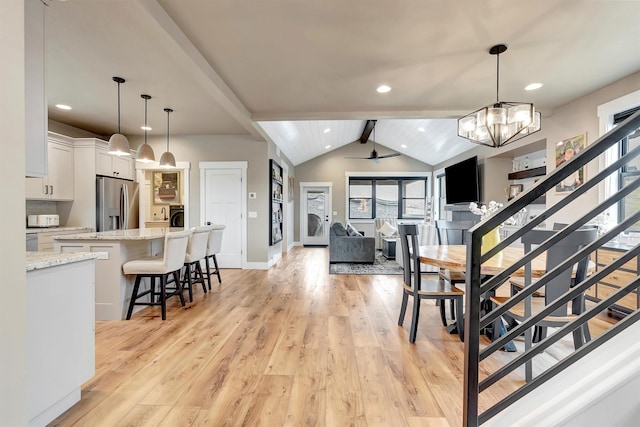 interior space featuring recessed lighting, stairway, vaulted ceiling with beams, light wood-type flooring, and baseboards