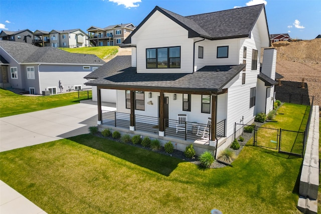 7038 Max Dr, Missoula, MT 59803 - modern farmhouse featuring a porch, a shingled roof, driveway, and a residential view