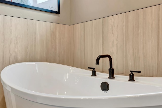 room details featuring a freestanding tub and a sink