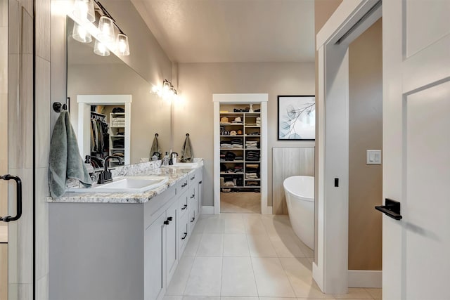 7038 Max Dr, Missoula, MT 59803 - bathroom with a soaking tub, a walk in closet, double vanity, and tile patterned flooring