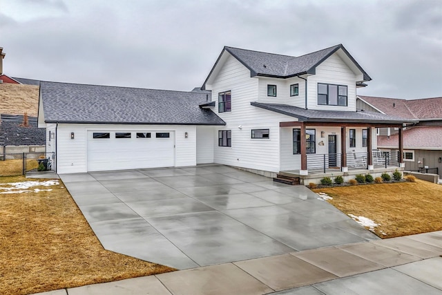 view of front of home featuring driveway, covered porch, fence, a garage, and a shingled roof