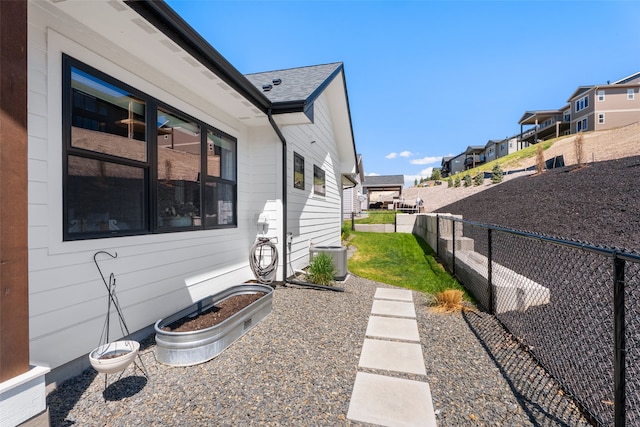 7038 Max Dr, Missoula, MT 59803 - view of home's exterior with fence, a residential view, and central AC unit