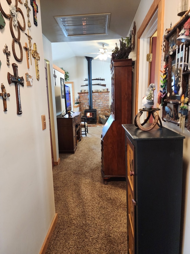 hallway featuring carpet floors and baseboards