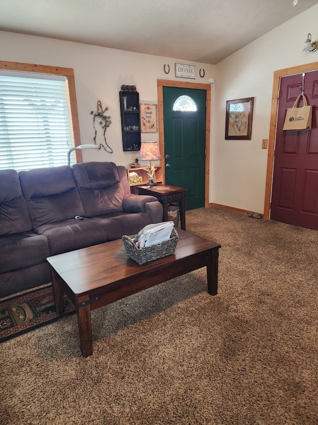 carpeted living room with baseboards and vaulted ceiling