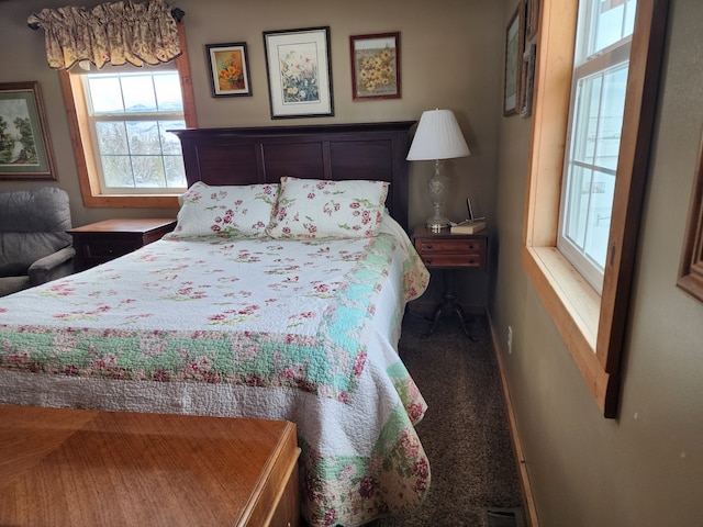 carpeted bedroom with baseboards and visible vents