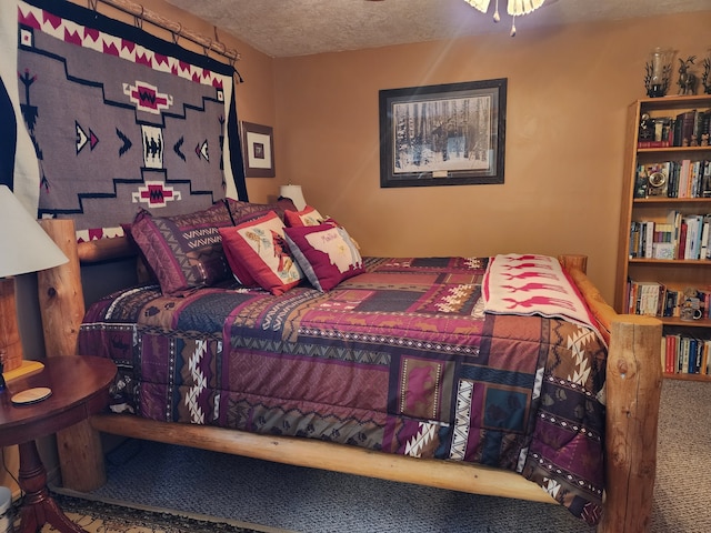 bedroom featuring carpet floors and a textured ceiling