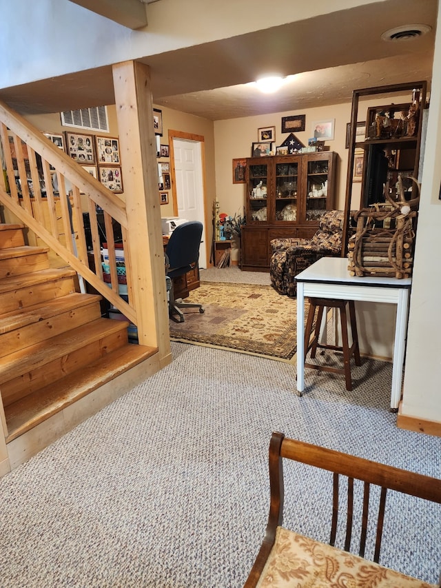 carpeted living room featuring stairs and visible vents