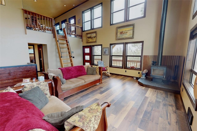87 Velvet Grv, Eureka, MT 59917 - living area featuring a wood stove, a high ceiling, stairs, wood finished floors, and recessed lighting