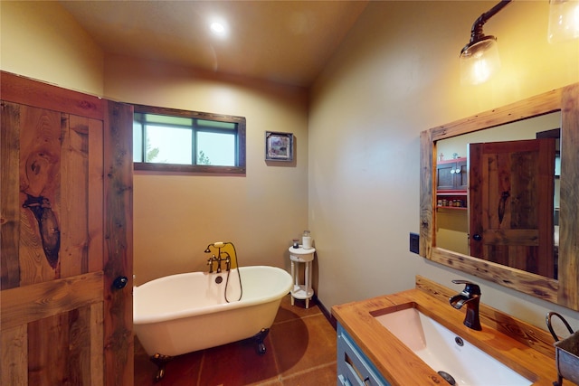 87 Velvet Grv, Eureka, MT 59917 - full bathroom featuring vanity, a freestanding bath, vaulted ceiling, and tile patterned flooring