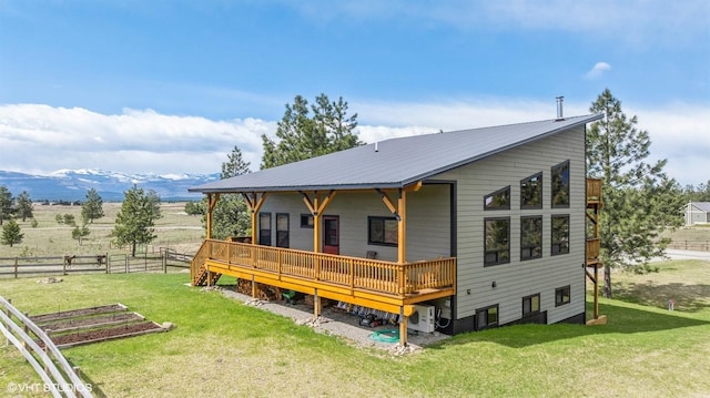 87 Velvet Grv, Eureka, MT 59917 - rear view of house featuring a wooden deck and a metal roof