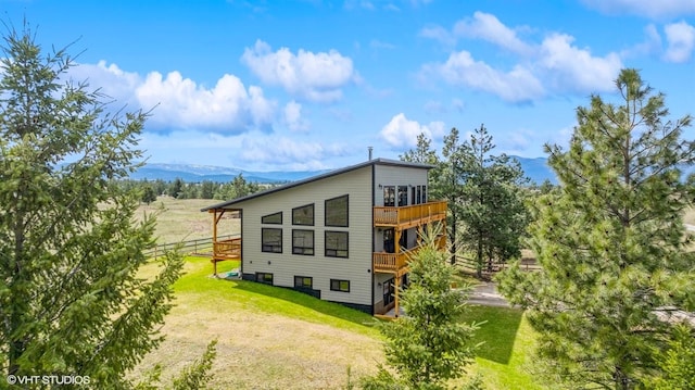 87 Velvet Grv, Eureka, MT 59917 - view of side of home featuring a deck with mountain view