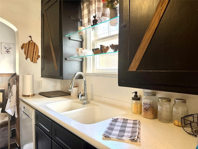 bathroom featuring a wainscoted wall and a sink
