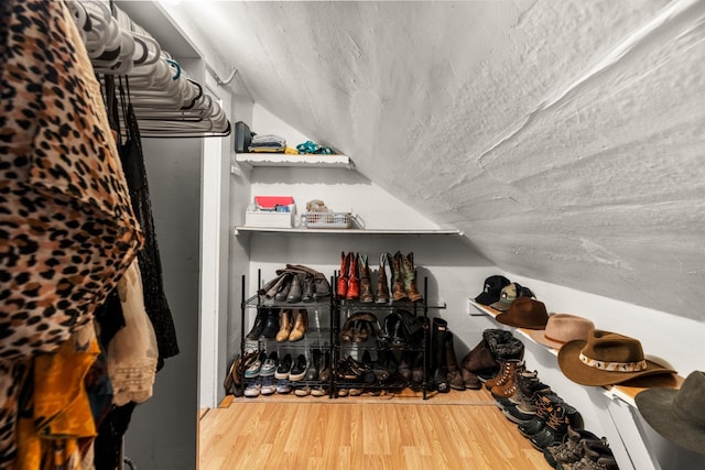 walk in closet featuring lofted ceiling and wood finished floors