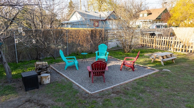 view of play area with a fire pit and a fenced backyard