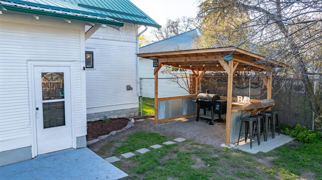 view of yard with outdoor dry bar, fence, and a gazebo