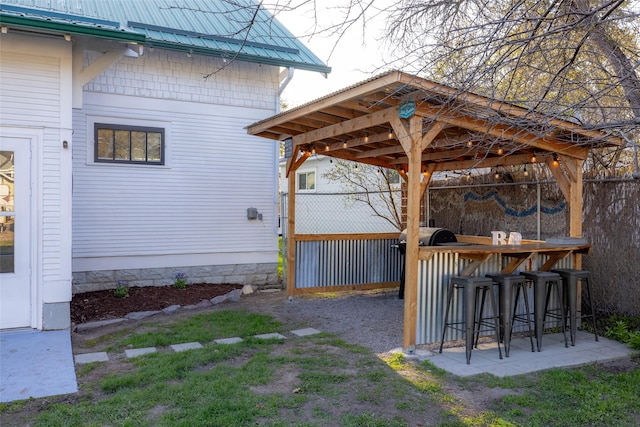 view of yard with outdoor dry bar and fence