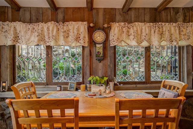 carpeted living area with wooden walls, a textured ceiling, and visible vents