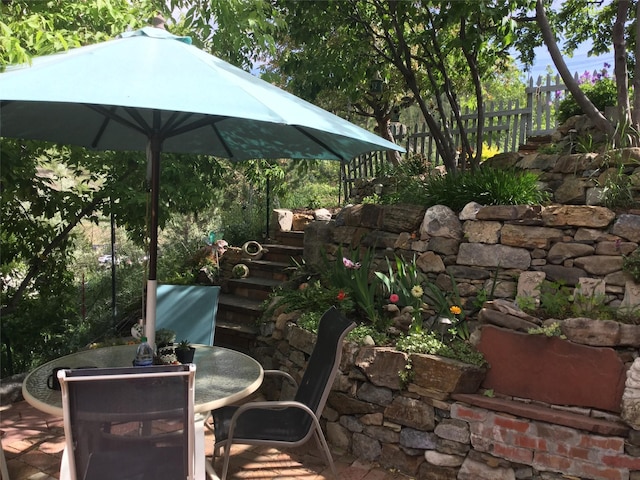 view of patio featuring fence and outdoor dining area