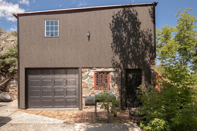 exterior space featuring stone siding and stairs