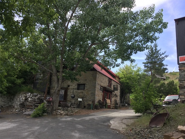 exterior space featuring stone siding