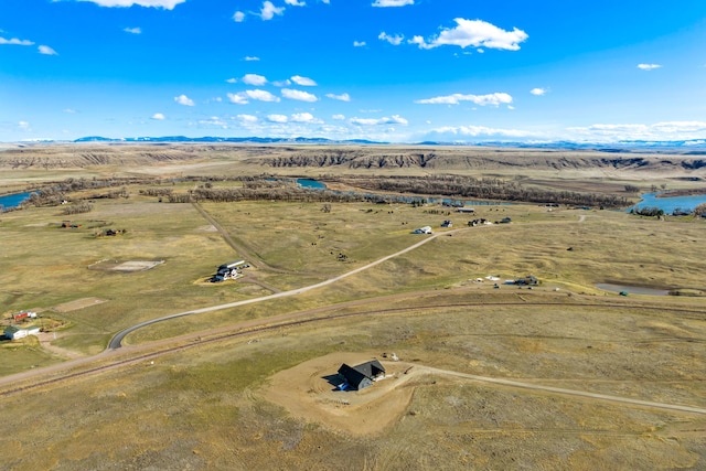 birds eye view of property with a water and mountain view