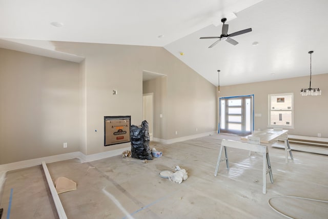 unfurnished living room with baseboards, a ceiling fan, and high vaulted ceiling
